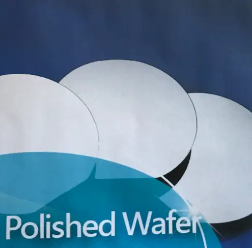 Polished silicon wafers stacked against a blue background.